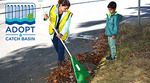Mother and son clearing a street catch basin Mother and son clearing a street catch basin