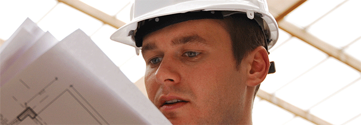 Worker looking at building specs Worker looking at building specs