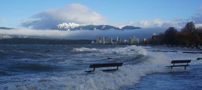 Sea level risen and waves are crash over a flooded park bench Sea level risen and waves are crash over a flooded park bench