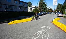 Person riding a bike on a street - Slow Streets Person riding a bike on a street - Slow Streets