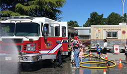 Families standing near a firetruck Families standing near a firetruck