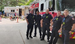 Firefighters standing in front of a firetruck Firefighters standing in front of a firetruck
